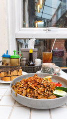 Kwetiau goreng  is a Chinese Indonesian stir fried flat rice noodle dish made from kwetiau, which are stir fried in cooking oil with garlic, onion ,beef, chicken, fried prawn, crab and other vegetable