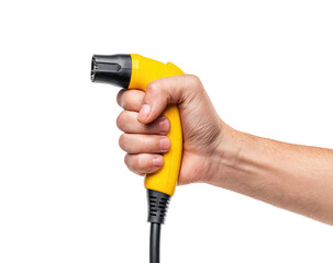 Hand holds yellow electric vehicle charging connector, ready to plug in