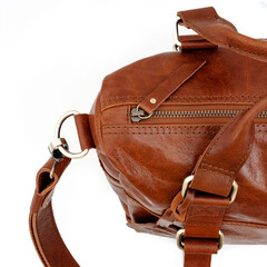 Detail of a beautiful tan leather bag for women on a white background