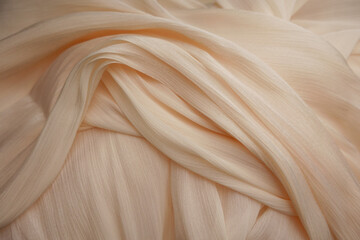 Soft pale fabric draped elegantly on a surface