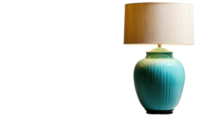 A turquoise ceramic table lamp with a cream shade against black