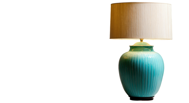A turquoise ceramic table lamp with a cream shade against black