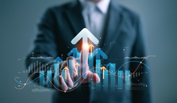 Businessman pointing at upward arrows with bar charts and data graphs, symbolizing financial growth, market success, business analytics, and future trend strategy, Performance Optimization.