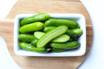 Fresh mini baby cucumbers on white background