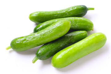 Fresh mini baby cucumbers on white background