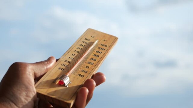 Observing temperature changes with a thermometer outdoors