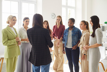 Woman discussion group gathering in room, female diverse friends, business successful confident...