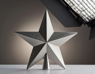 Silver star shines brightly as a christmas tree topper on a white surface, creating a festive and elegant holiday atmosphere.
