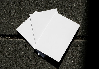 Stack of Square White Cards on a Speckled Gray Background with Soft Lighting Close Up View