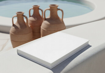 White Book with Blank Cover Near Three Clay Jugs and Swimming Pool in Background Under Bright Sunlight on Stone Surface