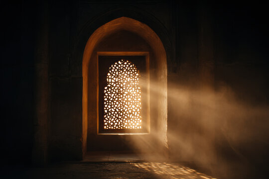 Sunlit arched lattice window in ancient Islamic prayer hall casting patterned light and warm dust rays across stone floor, atmospheric and serene interior with ornate geometric screen