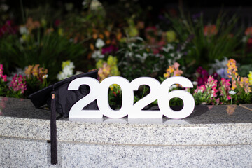 Celebrating Graduation 2026 With a Cap and Flowers in a Colorful Outdoor Setting © Liana
