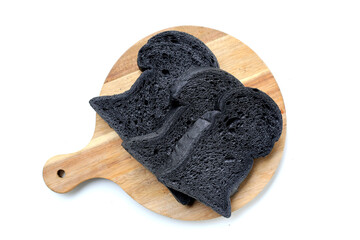 Black charcoal bread slices on white background