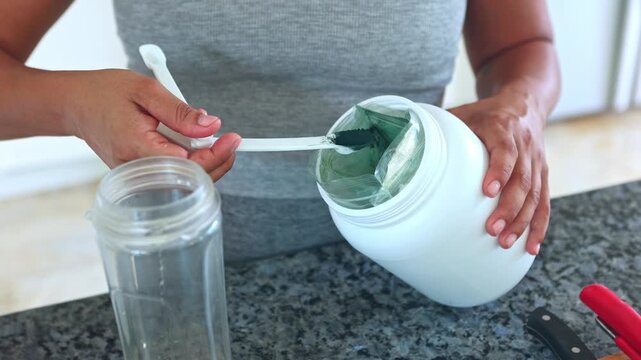 Woman preparing a spirulina protein shake for breakfast
