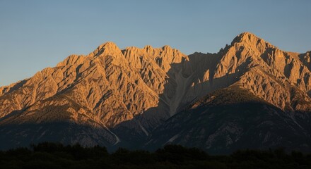 Majestic Golden Mountains at Sunrise with Clear Blue Sky