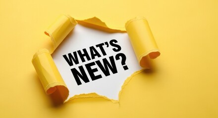 Torn Yellow Paper Reveals "What's New?" Message Concept