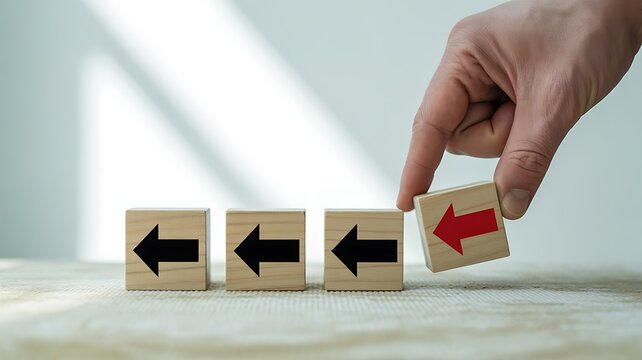 Changing Direction A Hand Flipping a Red Arrow Cube, Challenging the Status Quo