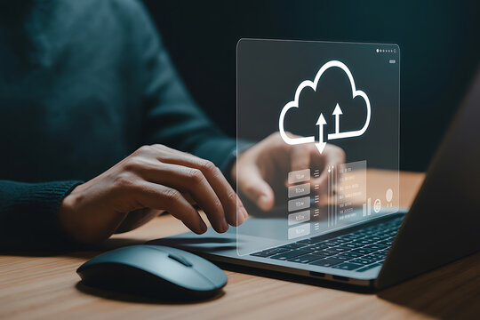 Hands typing on a laptop with a cloud computing interface displayed