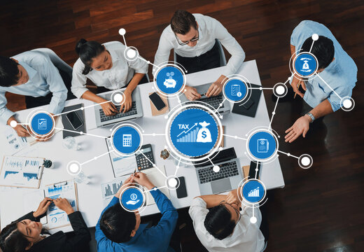 A dynamic business team engages in collaboration for financial strategies, focusing on tax planning and leveraging digital tools in a modern office setting. Amity - Powered by Adobe