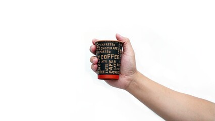 Isolated hand holding paper coffee cup with black lid. Enjoying takeaway coffee with stylish cup