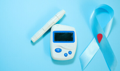 Healthcare and medical concept, Stethoscope and blood glucose meter sets on blue background, World Diabetes day, 14 November.