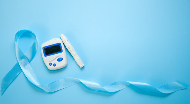 World diabetes day and blue ribbon awareness , isolated on a blue background. World diabetes day,14 november. Copy space. Top view - Powered by Adobe