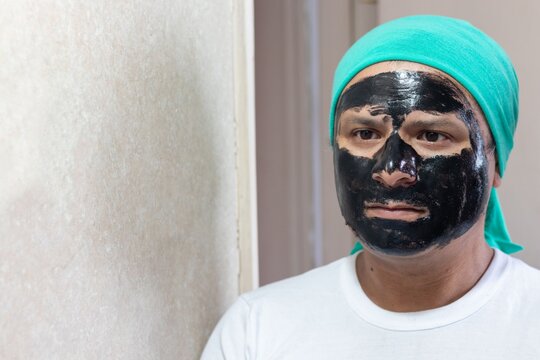 man with face mask in front of mirror