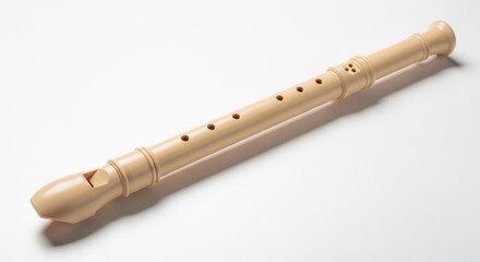 A light colored wooden recorder musical instrument on a white background