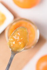 Orange fruit jam for a classic breakfast on white background
