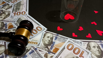 A symbolic image showing a judge’s gavel, dollar bills, and red heart shapes, representing the balance between love, money, and justice in relationships, divorce, or emotional decisions.