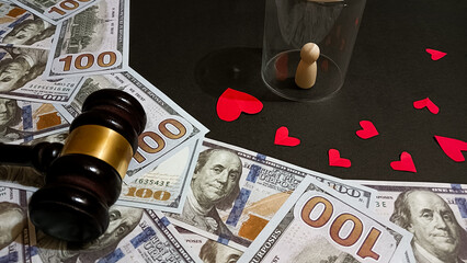 A symbolic composition showing a gavel, dollar bills, a wooden figure under glass, and red hearts, representing the balance between love, money, and justice in human relationships.
