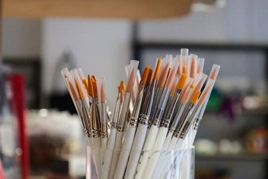 Close-up of New Artist Paintbrushes in a Clear Container.