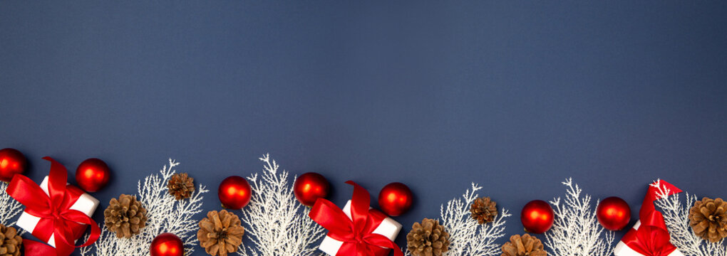 Merry Christmas and Happy New Year greeting card, frame, and banner. Holidays design. Noel and Feliz Navidad. Gifts and decorations, top view, flat lay. Text space, copy space winter background. - Powered by Adobe