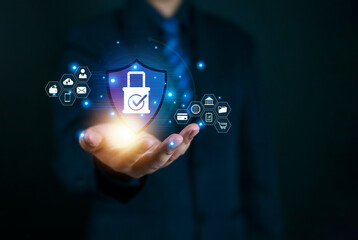 Cybersecurity protection concept with a businessman holding a digital shield and lock icon, symbolizing secure data, privacy, online safety, and information technology network security.