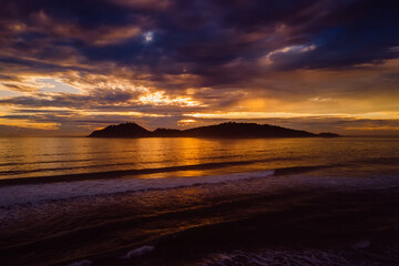 Sunrise and silhouette of Campeche island in Florianopolis. Aerial view.