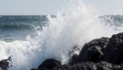 Ocean waves crashing on rocks, emphasizing nature's power, beauty, and dynamic atmosphere.