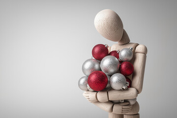 Wooden mannequin holding delicate silver and red Christmas balls, reflecting joy, unity, and warmth of holiday season, in artistic studio setup with soft shadows on white background 
