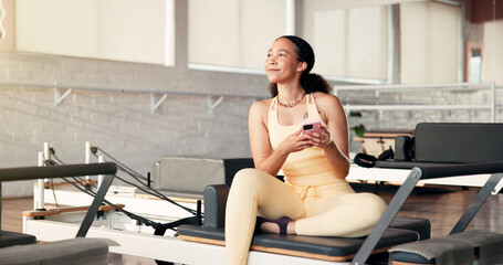 Thinking, smartphone and woman in studio, fitness and relax with digital app to track progress. Decision, connection and healthy person in wellness center, cellphone and social media with internet