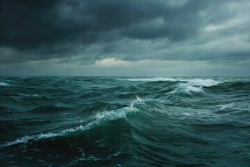 Fototapeta premium Rough sea with dark, ominous clouds looming overhead creating a stormy atmosphere