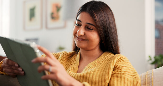 Streaming, happy or Indian woman on sofa with tablet, online reading or video update on social media. Smile, scroll or girl in house with tech, e book subscription or multimedia browse on digital app