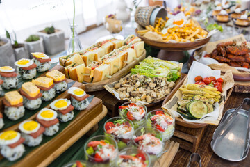 Colorful buffet table with sushi and salad cups