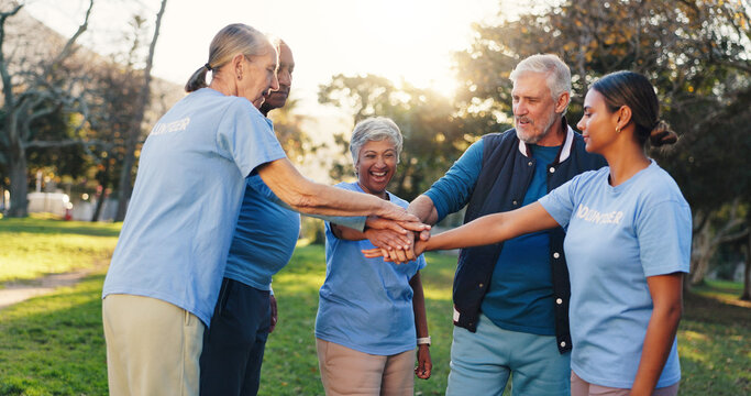 People, volunteer and stack hands at park, motivation and celebration with social responsibility. Women, men and excited with senior team, support or goals with success at charity event in summer