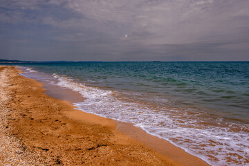 A deserted sandy beach on a summer day.