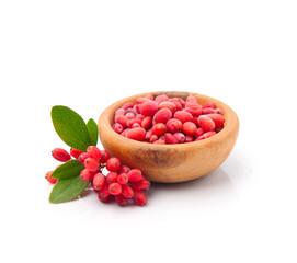 Barbarum berries in wooden plate and twig barberries berries