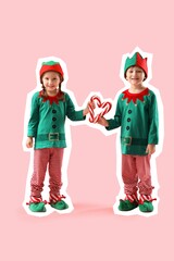Cute little elves making heart with candy canes on pink background