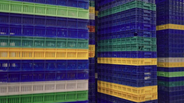colorful stacks of plastic crates used for seafood storage and transport in karachi fish processing plant