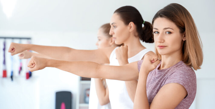 Young women training at self defense courses in gym