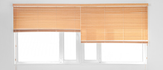 Stylish wooden blinds on window in living room