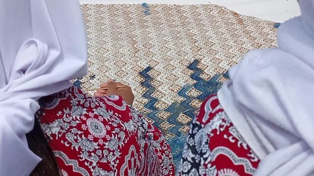 student doing batik on clothes