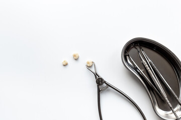 Many dental metal tools and teeth crows for implantation on white background. Professional Dentist desktop, top view